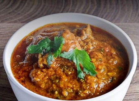Lamb curry — tender slow-cooked lamb in a deeply spiced curry sauce at Angeethi Flame Saskatoon